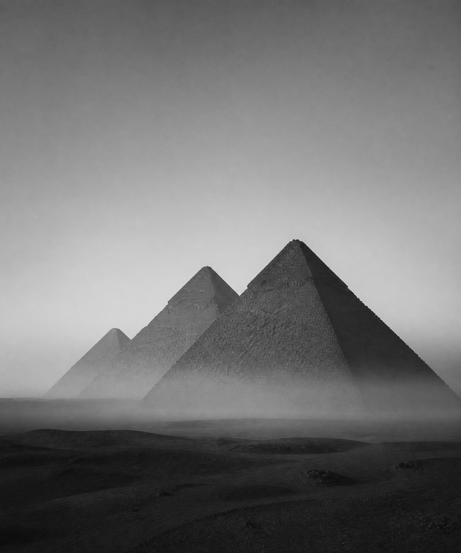 The pyramids of Giza in desert haze, black and white
